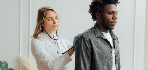 Doctor performing a physical check-up with a stethoscope